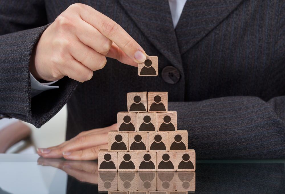 Image of a businesswoman with structured blocks representing people, symbolizing structured salary reviews
