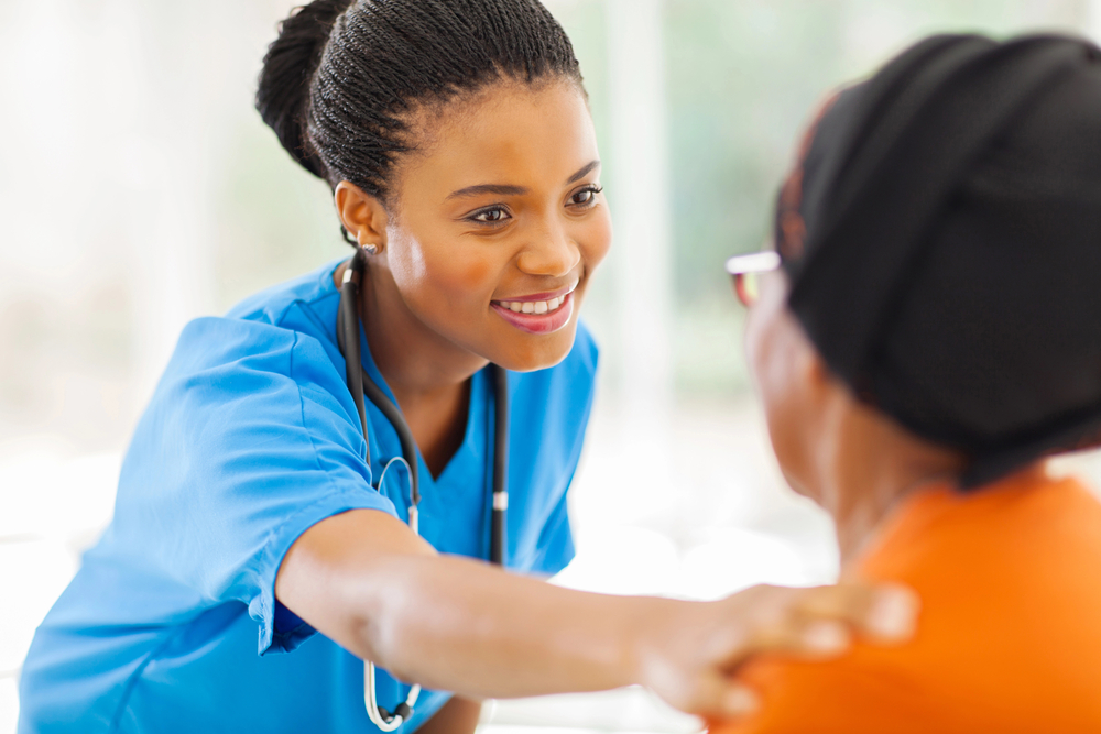 Image of a lady with a hand on another lady's shoulder showing enhanced patient care