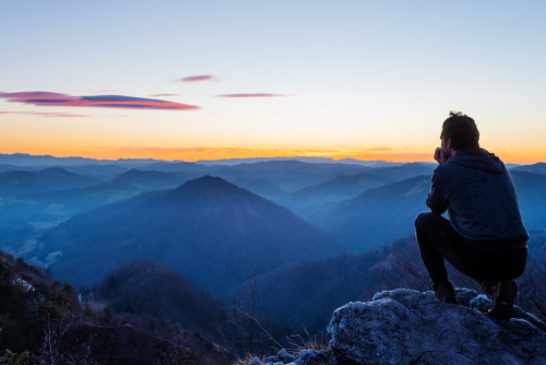 image of a man looking out and reflecting