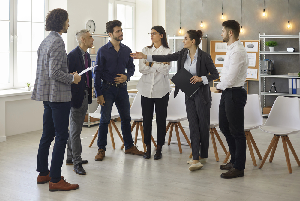 image of team members discussing something in a group showing team dynamics