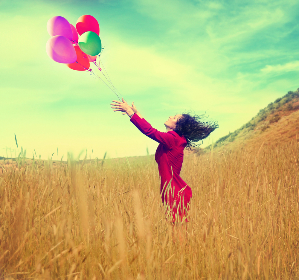 lady letting go of balloons