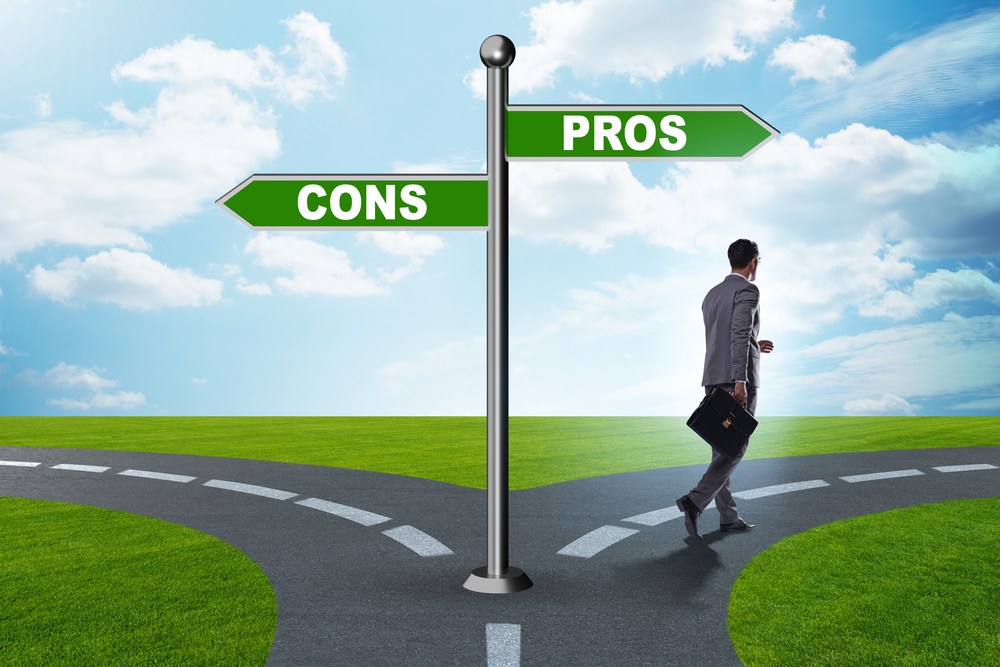 Image depicting a sign post with pros and cons on each side, representing the process of weighing options to make a decision