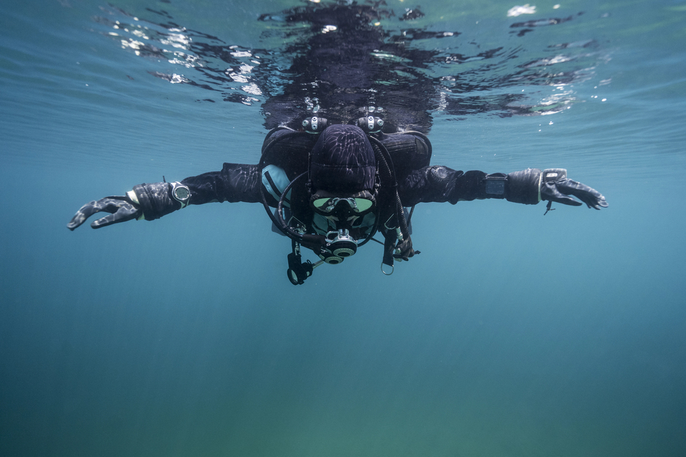 scuba diver going just below the surface